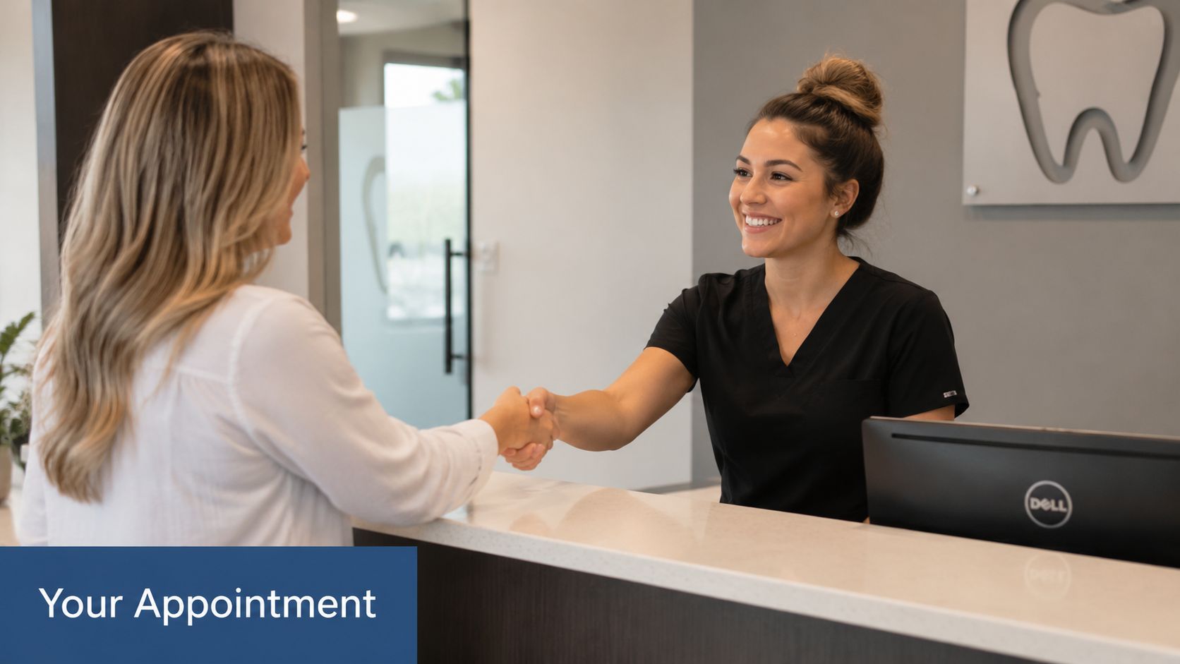 A friendly dental receptionist shaking hands with a patient at a modern medical office front desk.